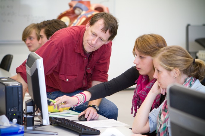 [Image: Thom at work; explaining students about the electric activity of the heart.